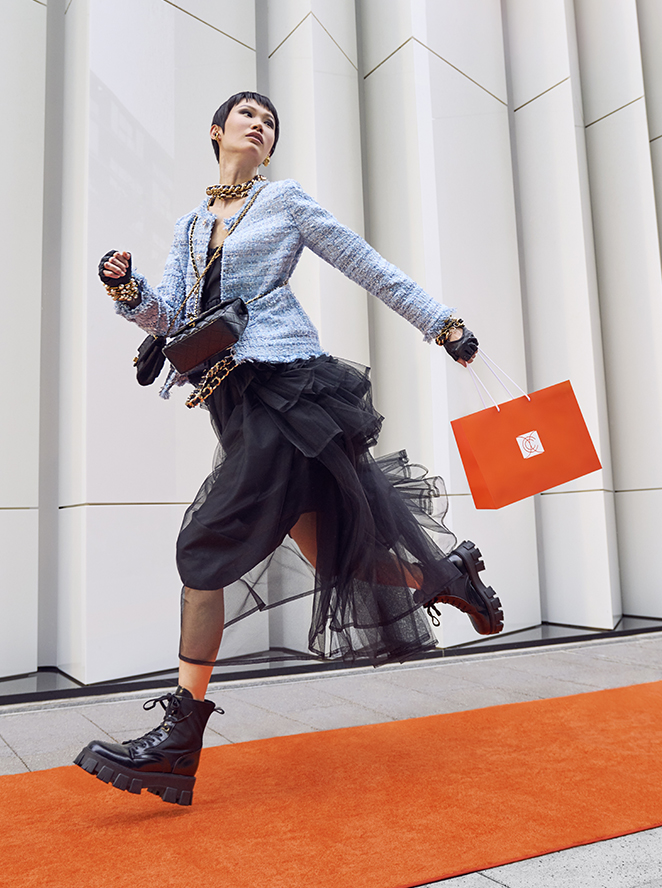 Woman running with shopping bag. Chanel Store at CitYCenterDC